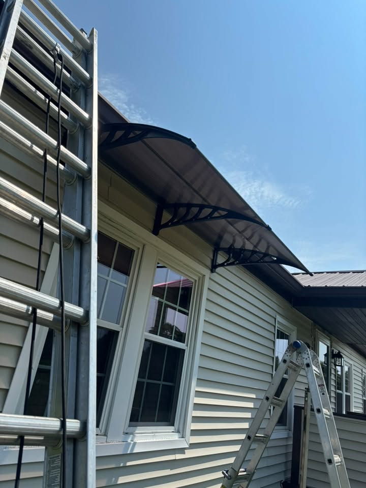 Window awning installation on a home by K&S Contracting LLC